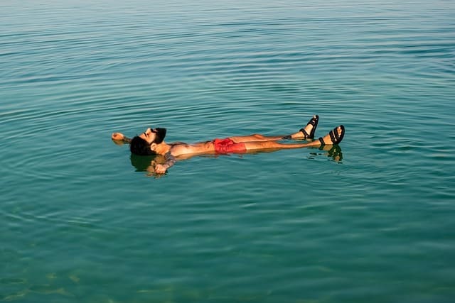 man meditating laying on the dead sea