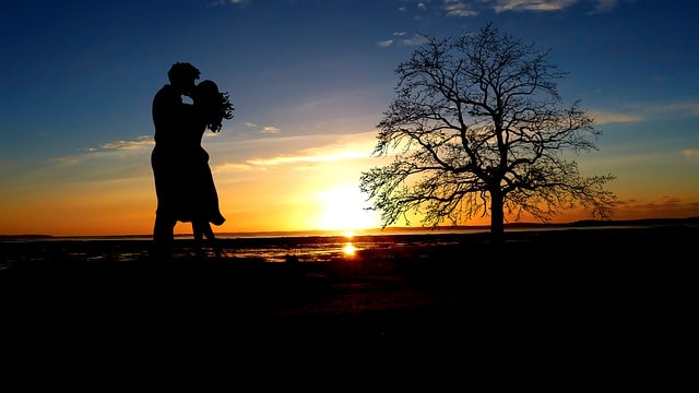 Silhouette of couple in a close, peaceful embrace